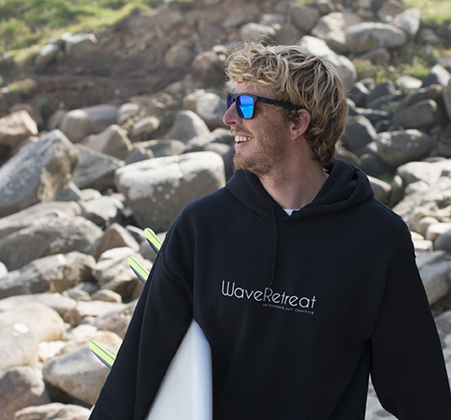 Rich Lacey, founder of WaveRetreat, with his surfboard
