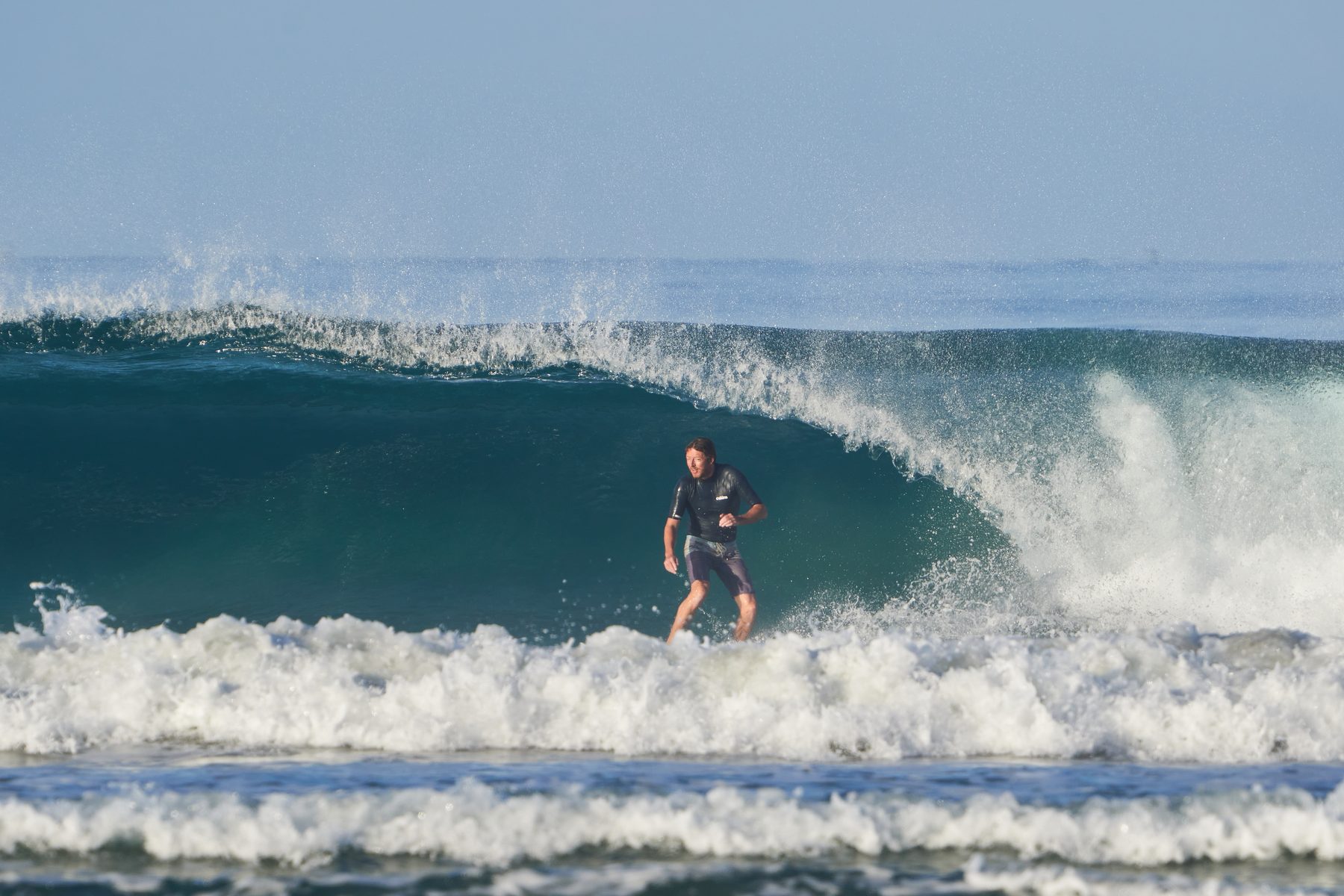 Tucked under a clean wave